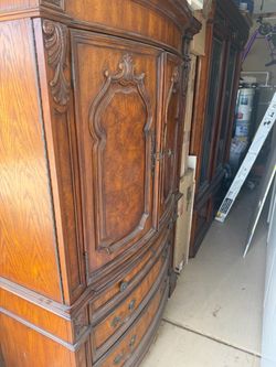 Ornate Wood Armoire with Carved Details