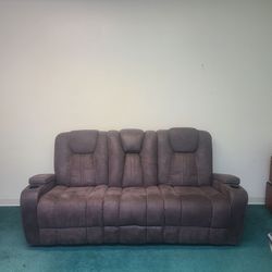 Suede recliner couch with charging ports.