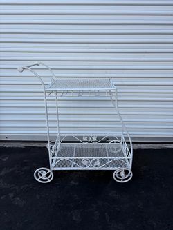 Vintage white wrought iron rolling tea or bar cart, similar in style to designs by Woodard USA or classic mid-century patio serving carts, featuring a