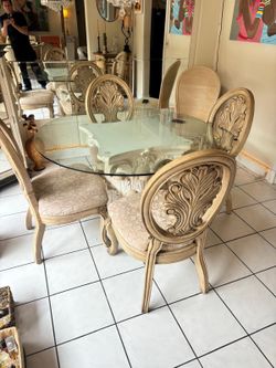 54” glass top dining table with 4 solid wooden chairs . $125