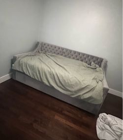 Gray upholstered twin bed with trundle by Little Seeds