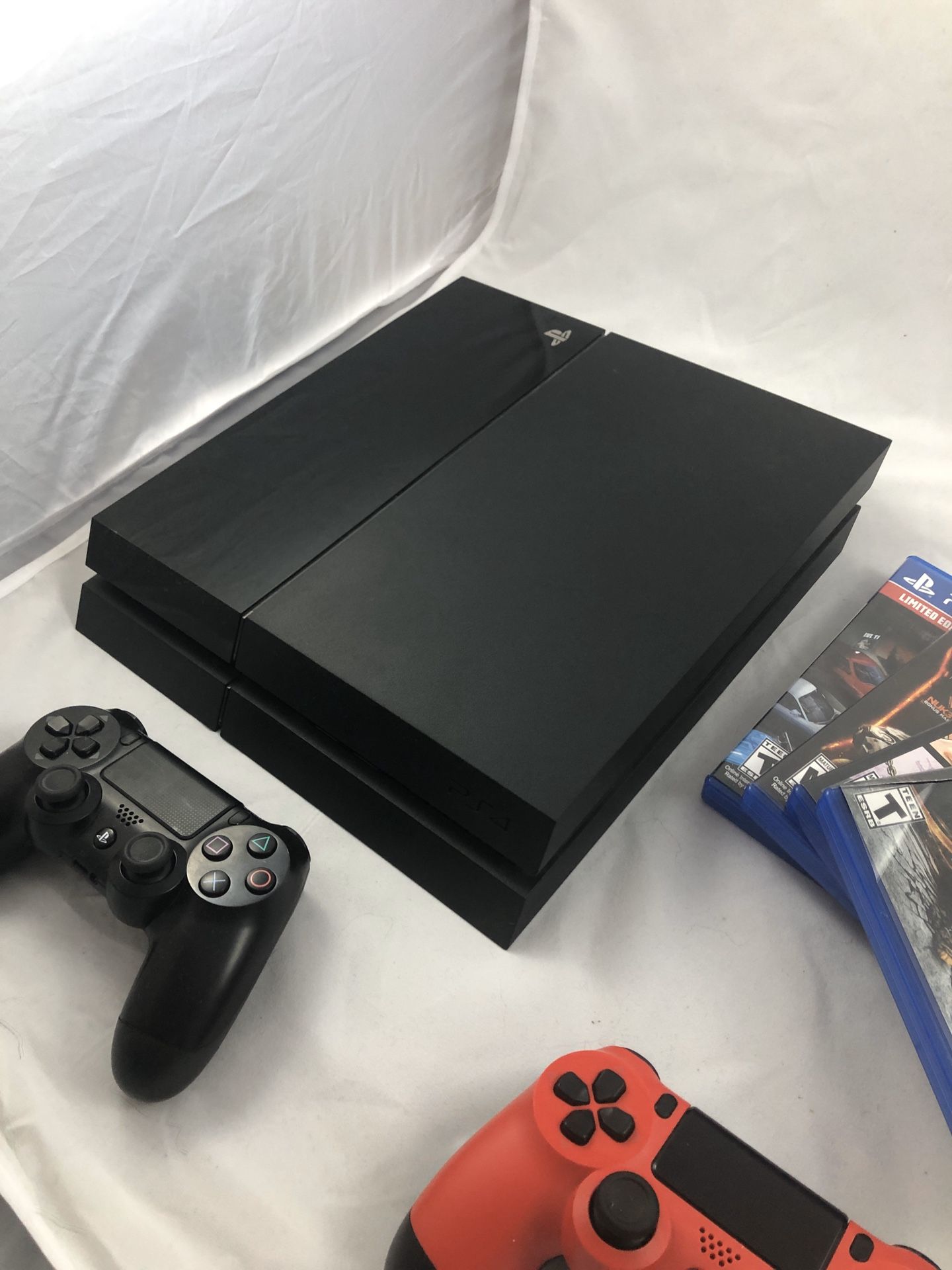 PS4 with 2 Controllers and 4 Video Games