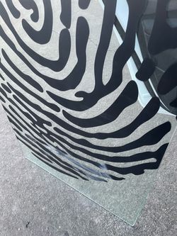 IKEA Glasholm tempered glass table top featuring a striking black fingerprint graphic pattern.