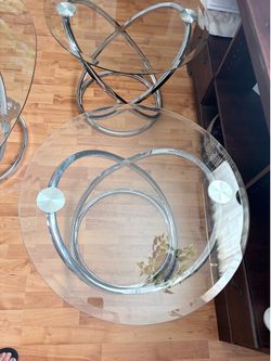 Warren three-piece glass, oval coffee table set chrome