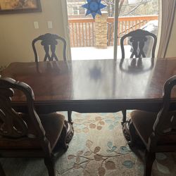 Wooden ornate dining table with 8 chairs & 2 leaves