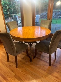 Kitchen table with metal base and 4 upholstered chairs.
