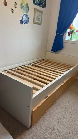 Twin bed with 3 drawers and mattress.