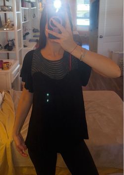 Black top with gray lace-like panel on the neckline