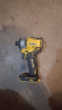 shows a DEWALT Atomic 20V MAX* Compact Brushless 1/4-Inch Impact Driver (DCF809), recognizable by its yellow-and-black body, metal nose cone, and comp