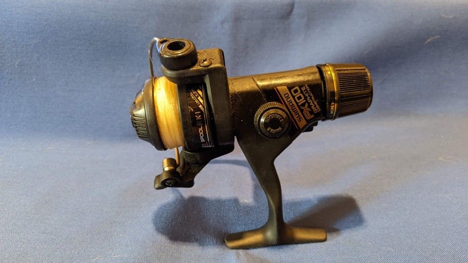 Shimano FX100/RK-1 Fishing Reel. Works Like New. Ready To Go With Line Spooled. Normal Wear And Tare. Quality You Can't Find In New Reels. Used.