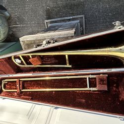 Vintage Olds Ambassador trombone in decent shape. The slide the valves all work. The case is in decent shape.  No huge dance or dings. Only one small 
