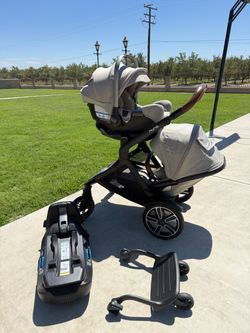 Nuna Double stroller, car seat, base, and ride along board