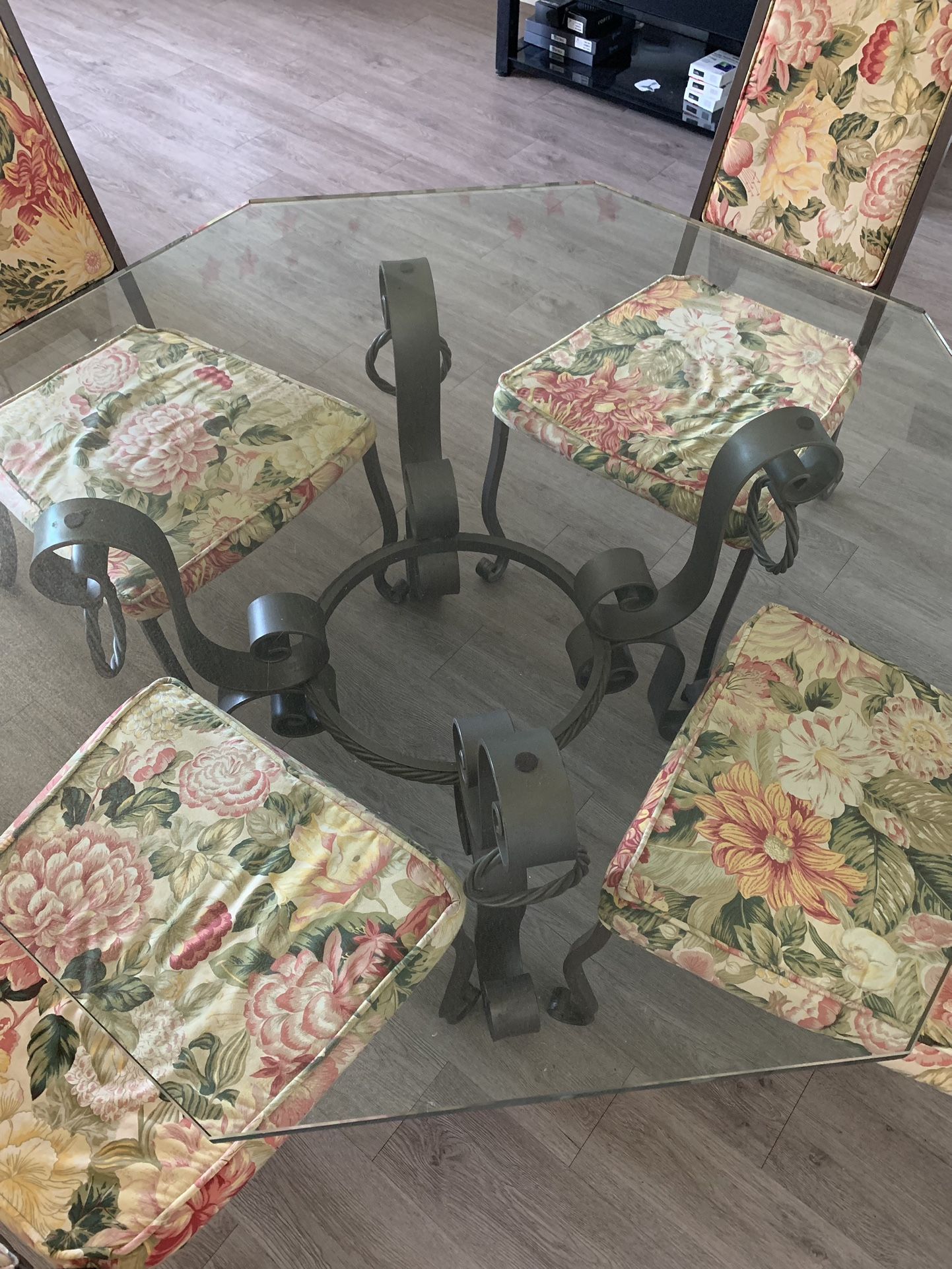 Forged table with glass top plus four wrought iron chairs β