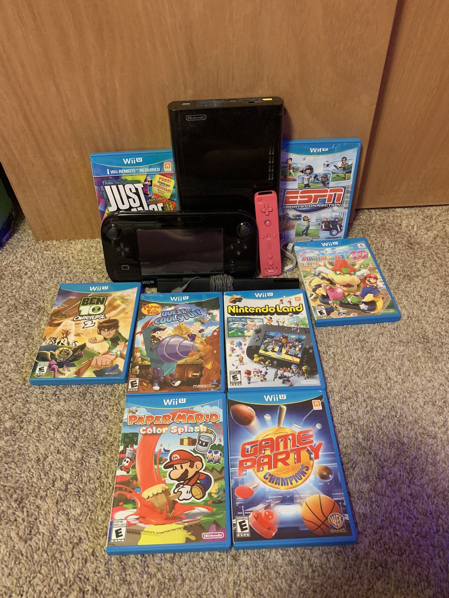 2016 black wii u with antena, pink wii controller, and 8 wii u games
