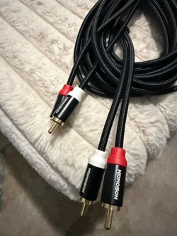 cable de audio RCA estéreo macho a macho (2 RCA → 2 RCA).