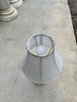 Table lamp in good condition. It stands 30 inches tall, and the shade measures 11 by 5 inches.