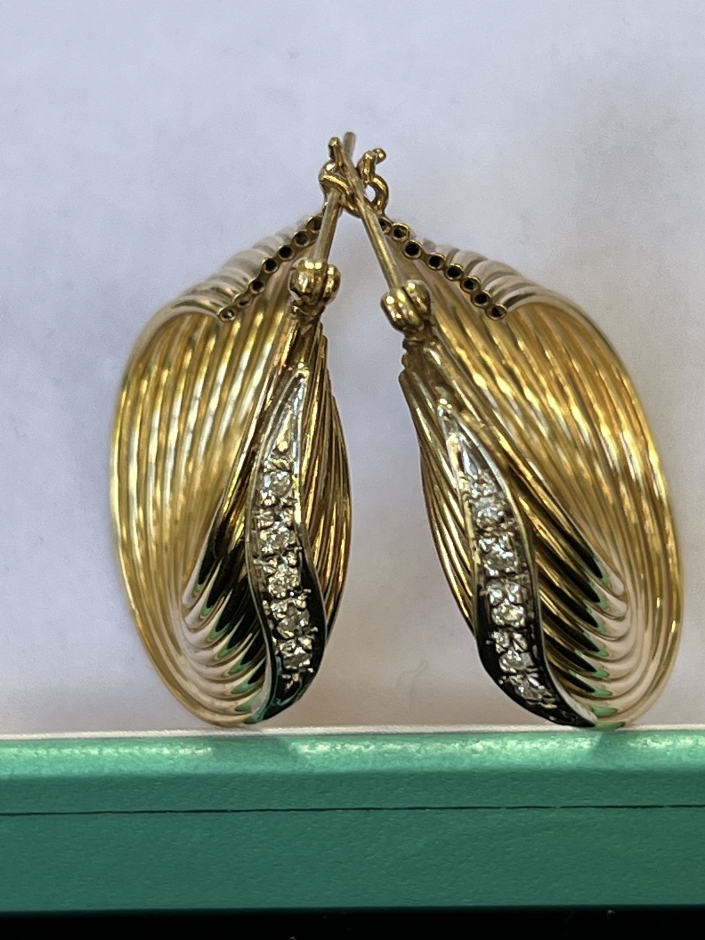 14 karat yellow gold hoop earrings with natural diamonds.