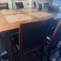 Height table  and 8 faux leather chairs