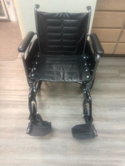 Black Folding Invacare Wheelchair with Footrests