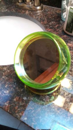 Mirror with storage compartment