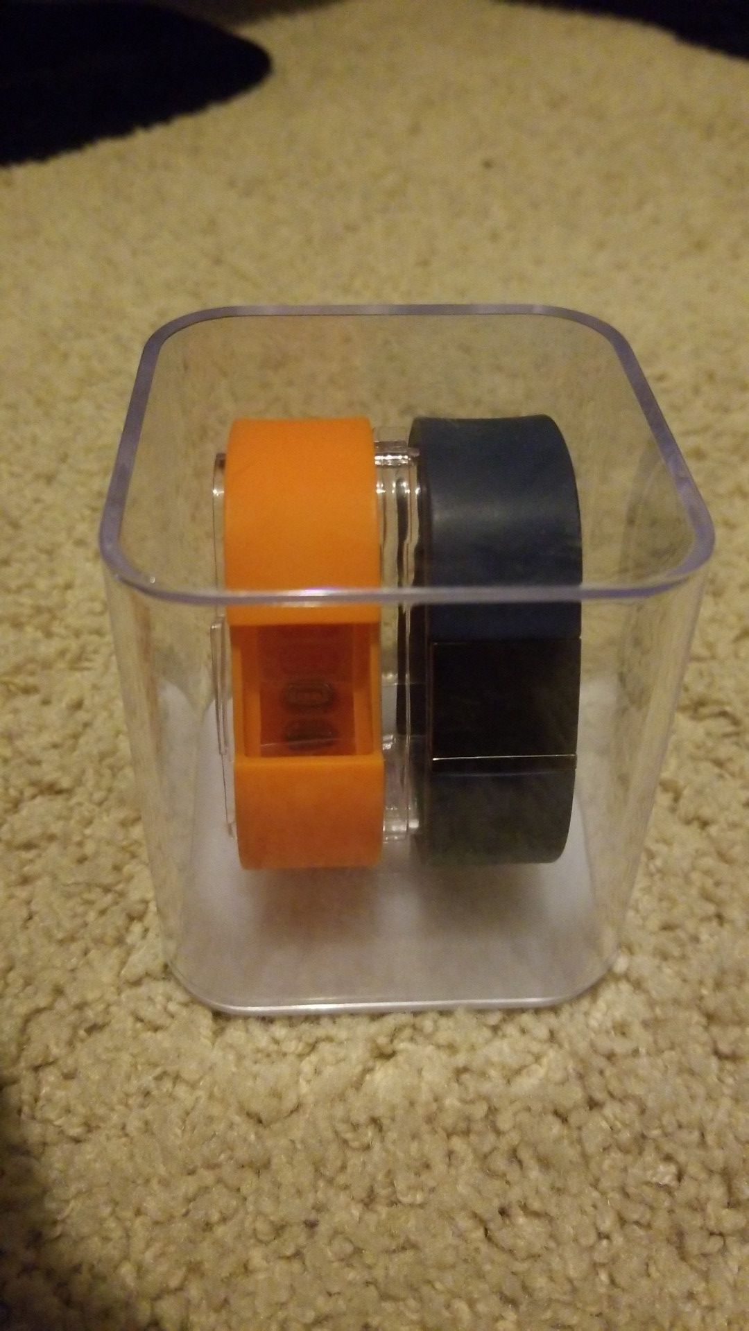 FitBit w/ two different bands, display case, and charger