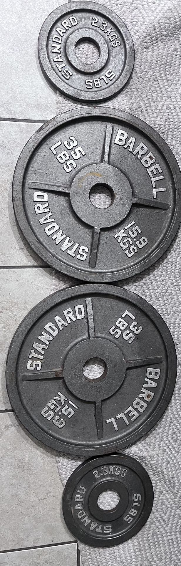 (2) 35lb Plates / (2) 5lb Plates / Adjustable Squat Stand / 2” Olympic Barbell / Set Of 2” Barbell Clips