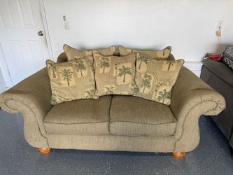 Tan Fabric Loveseat with Palm Tree Pillows