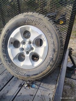 1 NewBridgestone Dueler A/T tire mounted on a rim.$85 Located Mount Dora Fla 32757