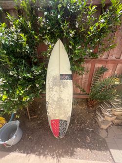 5’8 round tail surfboard