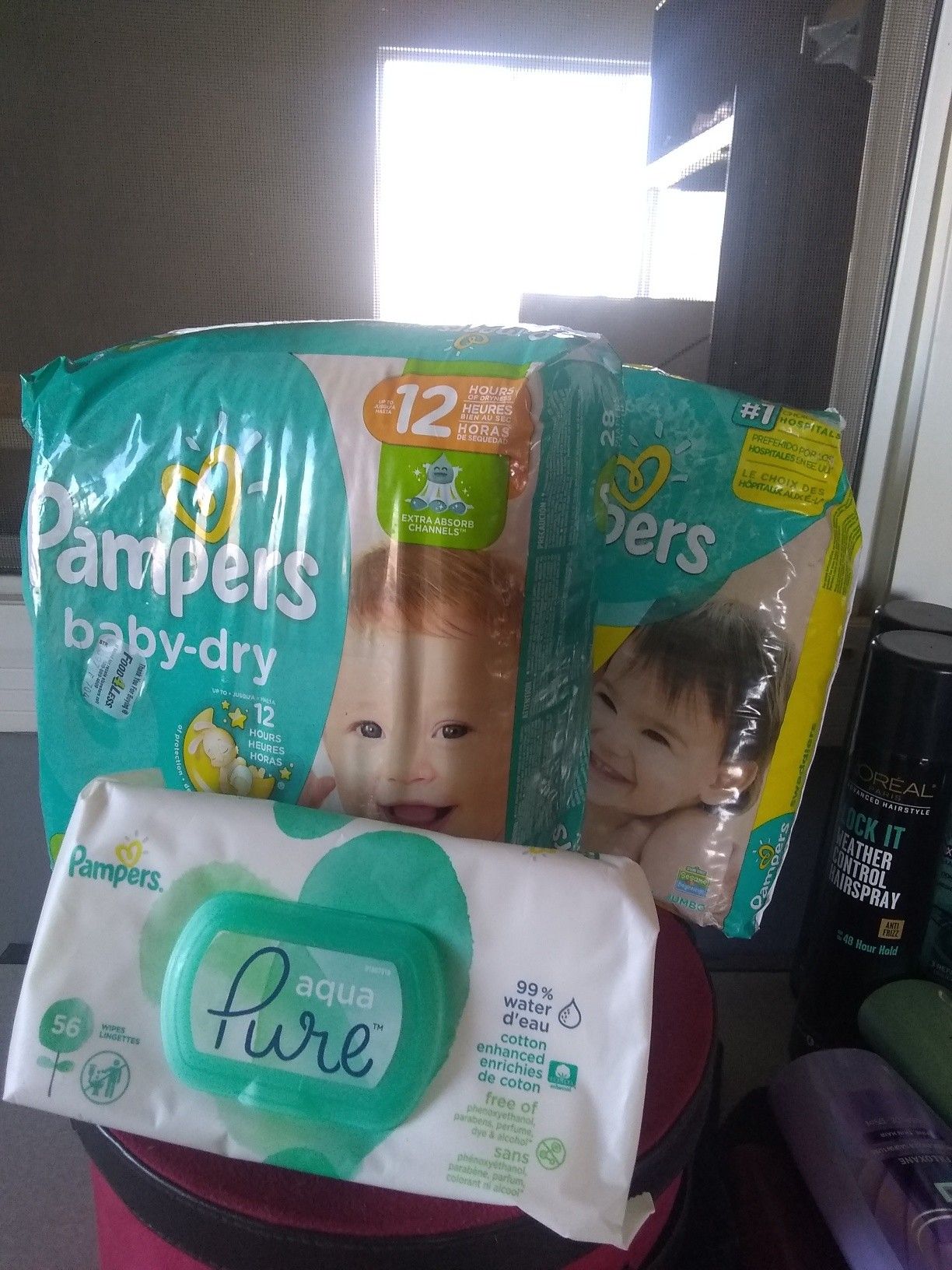 Two packs of jumbo pampers and one pack of wipes