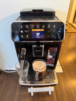 Sophisticated Philips 4300 Series fully automatic espresso machine in black. This unit has a built-in milk frother steam wand, a large touch-sensitive