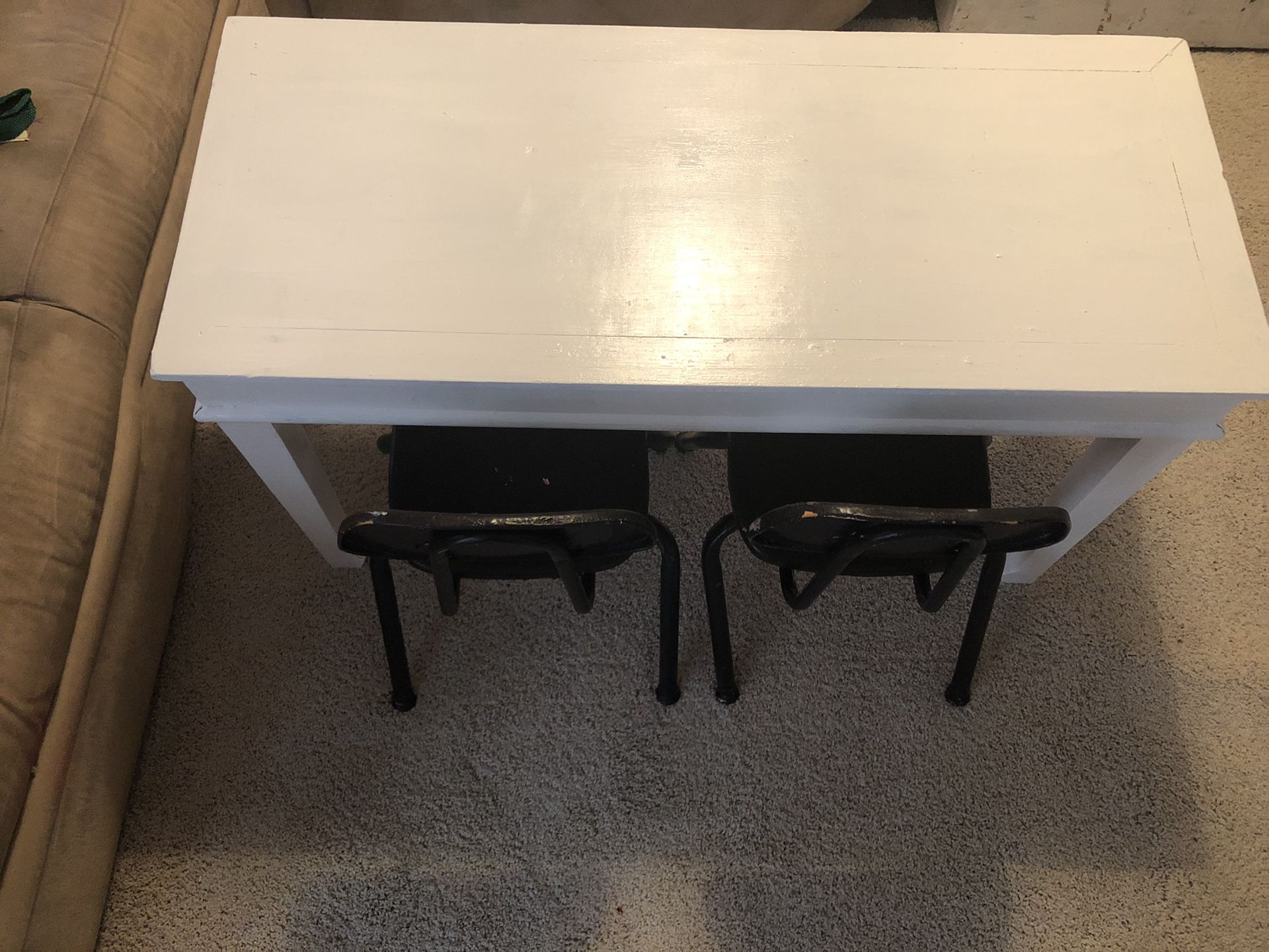 Toddler table and two black chairs