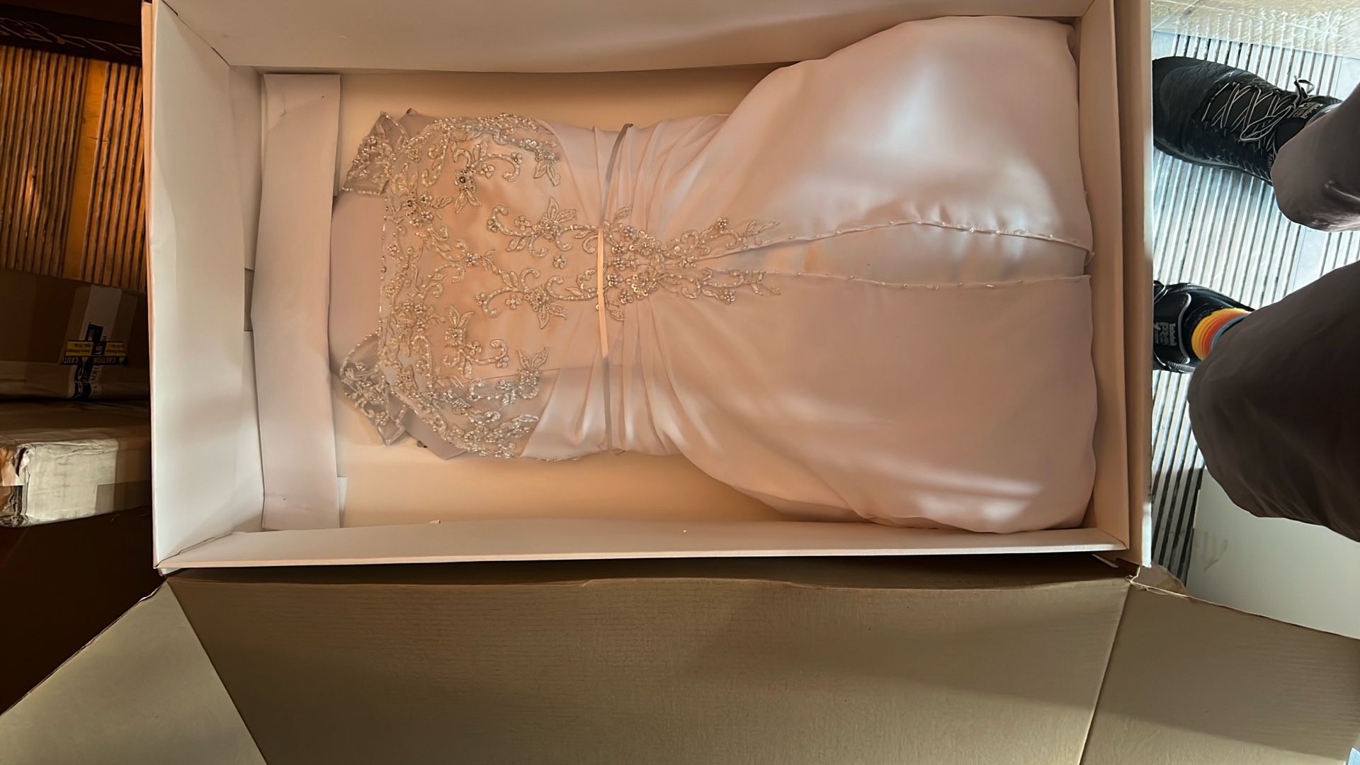 DAVIDS BRIDAL. This is a white bridal gown or wedding dress featuring a beaded bodice.