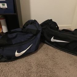 TWO NIKE LARGE DUFFLE BAGS