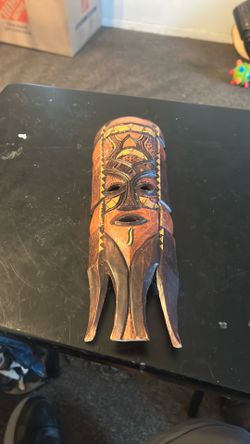hand-carved wooden decorative wall mask.
