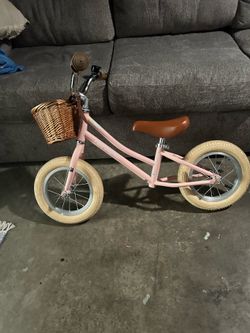 Kids pink balancing bike with basket