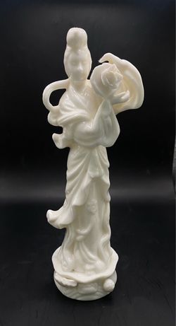 A vintage white porcelain figurine depicting Guanyin