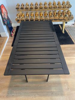 Foldable teak wooden outdoor patio table.