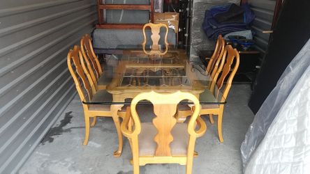 Glass dining room table & 6 wooden & fabric chairs