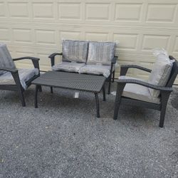 Outdoor patio wicker loveseat with chairs and coffee table 