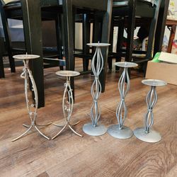 5 silver metal pillar candle holders, distinctive twisted wire design. good condition