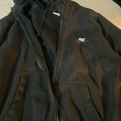 This is a black Nike full-zip fleece hoodie