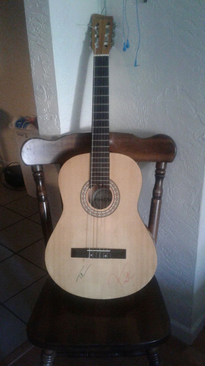 Acoustic guitar with Tim McGraw and Faith hills autographed signature at the bottom GREAT CONDITION!