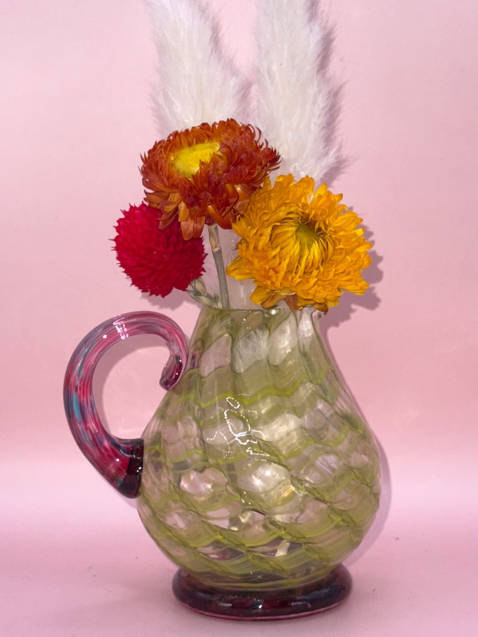 vintage spatter glass pitcher, likely dating back to the late 19th or early 20th century.