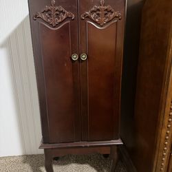 Jewelry armoire with mirror and drawers