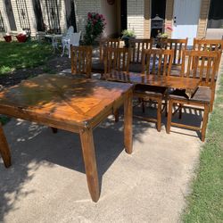 Wooden table with leaf and 8 matching chairs