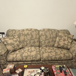  Fabric Loveseat Sofa  with Green and yellow gold flower design on fabric attached with a metal fold out bed under sofa 