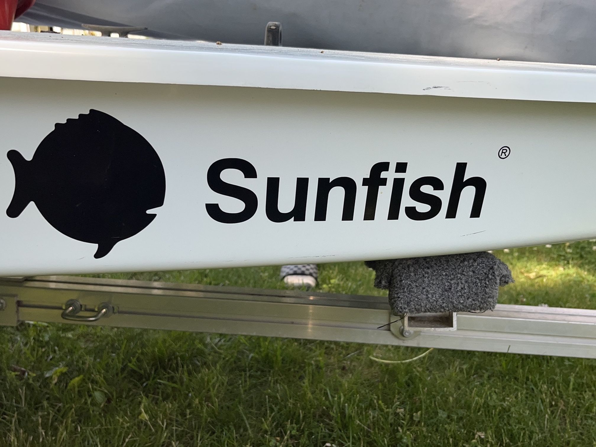 Slightly used sunfish with racing sail, trailer & dolly