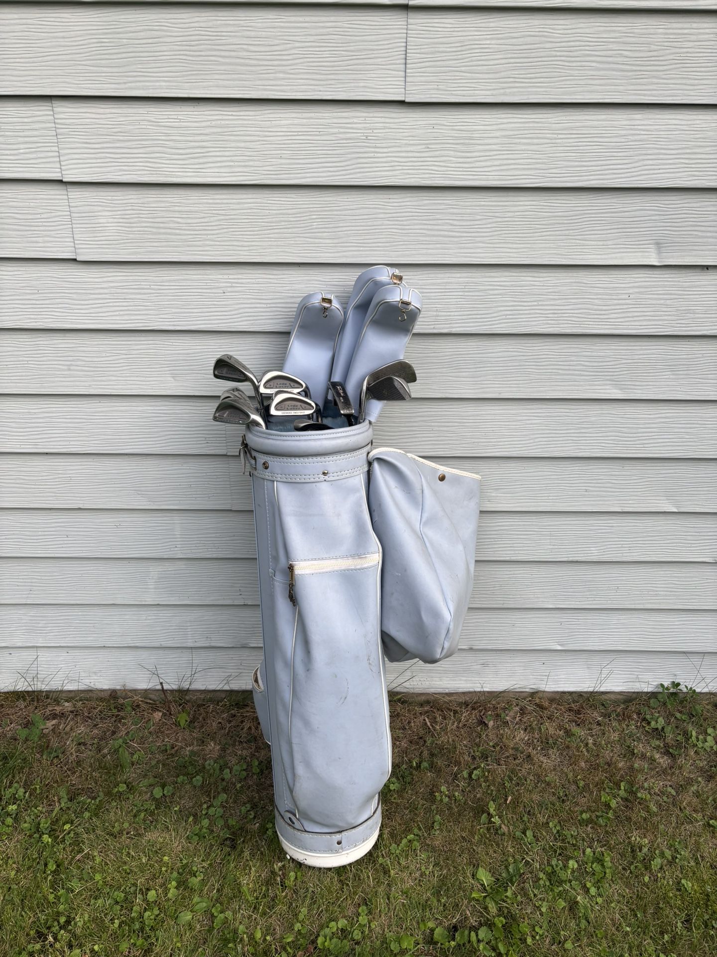Various Women’s Golf Clubs Inside Blue Bag