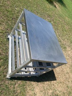 commercial stainless steel mobile prep table or utility trolley with a metal frame and rolling casters